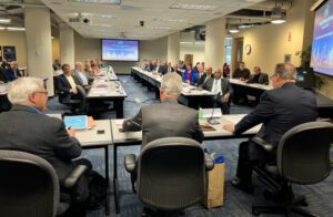 OKI Board Meeting room with members looking at the panel