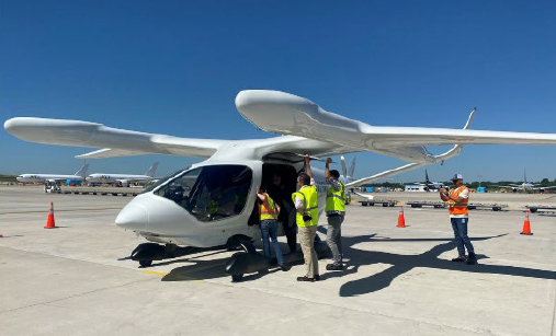 People standing next to flight vehicle